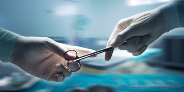 healthcare and medical concept , Close-up of surgeons hands holding surgical scissors and passing surgical equipment , motion blur background.