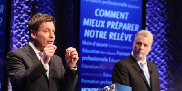 Quebec's Liberal Party leadership candidate Pierre Moreau (L) speaks as Philippe Couillard looks on during their first debate in Montreal, January 13, 2013. REUTERS/Christinne Muschi (CANADA - Tags: POLITICS ELECTIONS)