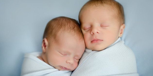 Twin newborn boys sleeping.