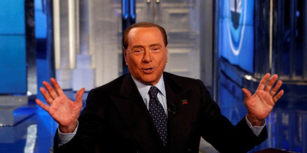 Italy's former Prime Minister Silvio Berlusconi gestures as he attends television talk show