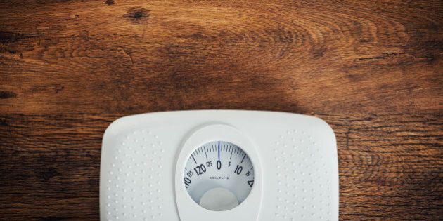 White scale on a wooden table top view, fitness and weight loss concept