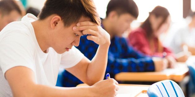 Stressed college student for exam in classroom