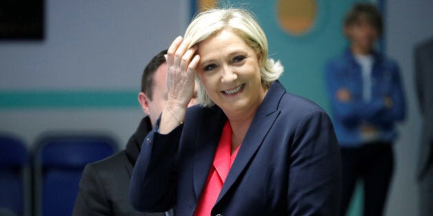 Marine Le Pen, French National Front (FN) political party candidate for French 2017 presidential election, smiles before voting in the second round of 2017 French presidential election at a polling station in Henin-Beaumont, France, May 7, 2017. REUTERS/Charles Platiau