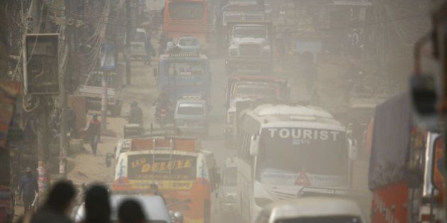 Dust blows as vehicles run along a road in Kathmandu, Nepal February 27, 2017. Picture taken February 27, 2017. REUTERS/Navesh Chitrakar