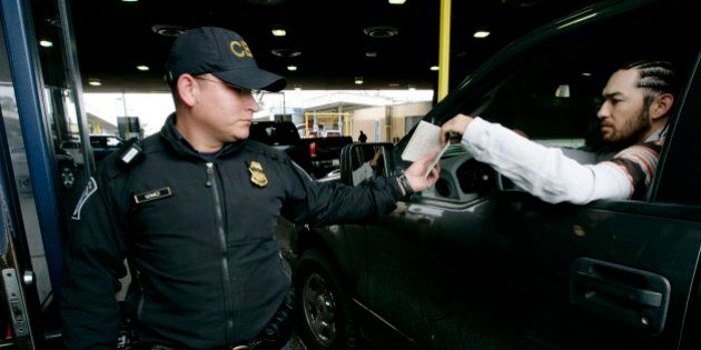 SAN YSIDRO, CA-, JUNE 1: Customs and Border Protection agent Jesus Gomez check ID's from motorists crossing into the United States from Mexico at the San Ysidro Port of Entry June 1, 2009 in San Ysidro, California. The Western Hemisphere Iniative (WHTI) was put into effect today at all Canadian and Mexican border crossings where visitors and residents must present an approved travel document when entering the U.S. at any land or sea ports of entry. These travel documents include a U.S. passport or passport card, as well as a Trusted Traveler Card (SENTRI, NEXUS or FAST) or an Enhanced Driver's License. (Photo by Sandy Huffaker/Getty Images)