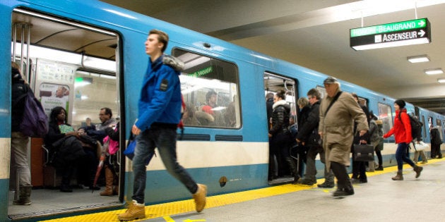 Montreal, PQ, Canada - December 2, 2015: People exit and board a train on Berry-UQAM subway station in Montreal