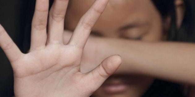 Little girl suffering bullying raises her palm asking to stop the violence