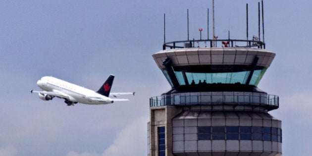 An Air Canada jet flies past the control tower at Montreal's Dorval International Airport, June 8. The Canadian government has taken preliminary steps to prevent a strike over working conditions by the country's 2,200 air traffic controllers by placing back-to-work legislation on the official parliamentary agenda.SB/TB