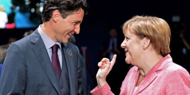 TOPSHOT - Canadian Prime Minister Justin Trudeau (L) talks to German Chancellor Angela Merkel during a NATO Summit session on Ukraine at the NATO Summit in Warsaw, Poland on July 9, 2016.The Polish capital hosts a two-day NATO summit, the first time ever that it hosts a top-level meeting of the Western military alliance which it joined in 1999. / AFP / JANEK SKARZYNSKI (Photo credit should read JANEK SKARZYNSKI/AFP/Getty Images)