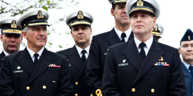 Rear-Admiral Tyrone Pile (R), Commander of Canadian Maritime Forces Pacific, displays new braid on his sleeves along with other naval officers during a ceremony in Victoria, British Columbia June 11, 2010. The braid re-instates the executive curl to naval officers after it was dropped following the integration of the Canadian Forces in 1968. The executive curl is emblematic of navies around the world and originated in the Royal Navy around 1800. REUTERS/Andy Clark (CANADA - Tags: MILITARY)