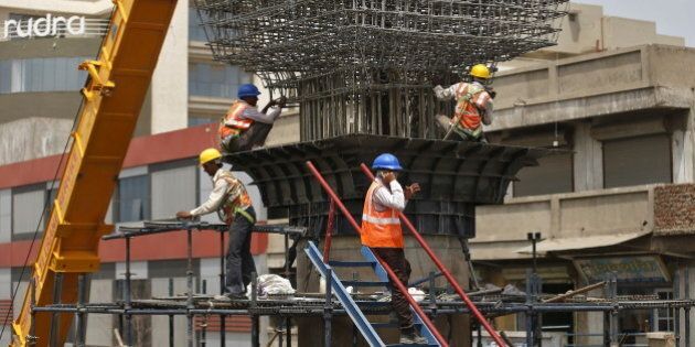 Labourers work at the site of metro railway flyover under construction in Ahmedabad, India, March 31, 2016. India's infrastructure output grew an annual 5.7 percent in February, its fastest pace in at least 13 months, mainly driven by a surge in production of cement and fertilizers, government data showed on Thursday. REUTERS/Amit Dave