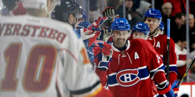 Jan 24, 2017; Montreal, Quebec, CAN; Montreal Canadiens forward Tomas Plekanec (14) reacts with teammates after scoring a goal against Calgary the Flames during the second period at the Bell Centre. Mandatory Credit: Eric Bolte-USA TODAY Sports