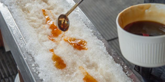 Maple taffy on snow during sugar shack period. In Quebec, Canada.