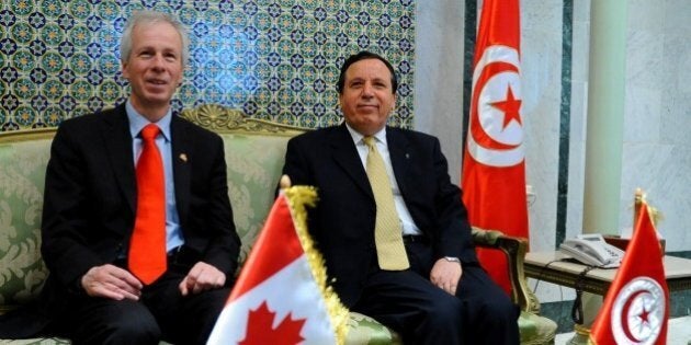 Tunisian Foreign Affairs Minister Khemais Jhinaoui, right, greets his Canadian counterpart, Stephane Dion prior to a joint press conference, in Tunis, Saturday, May 21, 2016. (AP Photo/Hassene Dridi)