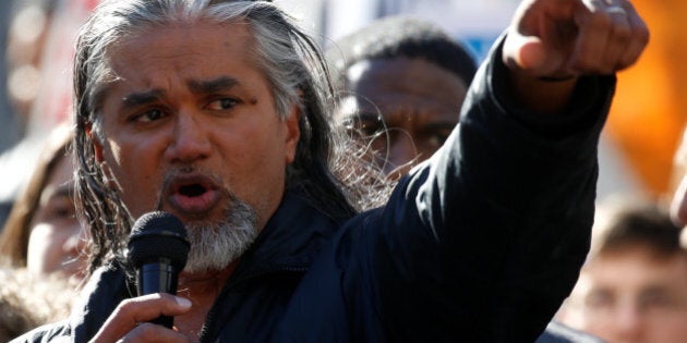 Immigration activist Ravi Ragbir points at the U.S. Citizenship and Immigration Services offices building before his immigration check-in with officials in New York, U.S. March 9, 2017. REUTERS/Carlo Allegri