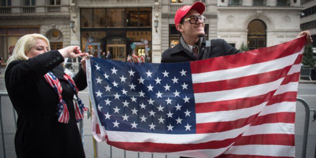 Supporters of US President Donald Trump hold a US flag during a rally near Trump Tower in Fifth Avenue, February 5, 2017 in New York. / AFP / Bryan R. Smith (Photo credit should read BRYAN R. SMITH/AFP/Getty Images)