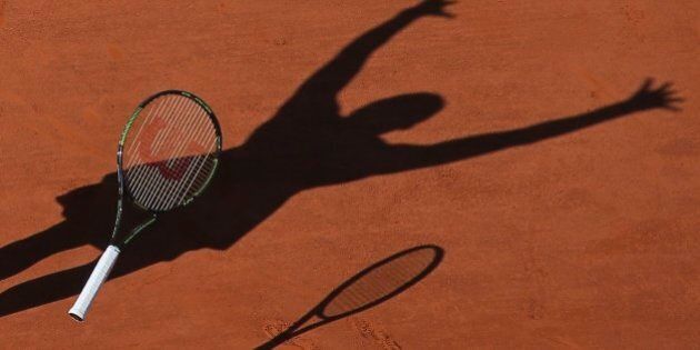FILE - In this Saturday June 6, 2015 file photo, Serena Williams of the U.S. casts a shadow on the clay as she drops her racket and celebrates winning the final of the French Open tennis tournament against Lucie Safarova of the Czech Republic in three sets, 6-3, 6-7, 6-2, at the Roland Garros stadium, in Paris, France. (AP Photo/David Vincent, file)
