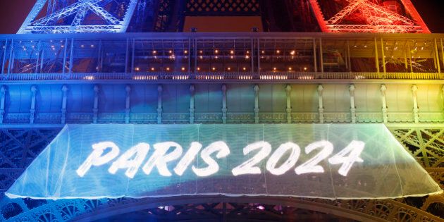 PARIS, FRANCE - FEBRUARY 03: The Eiffel tower is lit with the colours of the Olympic flag with the words 'Paris 2024' during the launch of the international campaign for the 2024 Olympic Games on February 3, 2017 in Paris, France. The city of Paris is candidate to host the Olympic Games in 2024. (Photo by Chesnot/Getty Images)