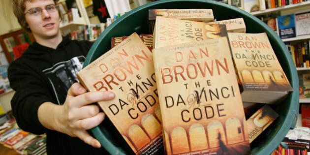 Melbourne, AUSTRALIA: Seb Prowse of the Trades Hall's New International Bookshop shows his collection in a rubbish bin as they attempt for a Guinness World Record for the largest collection of unwanted copies of Dan Brown's The Da Vinci Code, in Melbourne 18 June 2006. The bookshop is using the record attempt to promote their Big Red Book fair and hope to promote their new product line: Books Not By Dan Brown. They also say they are not into burning the books as they fear it is too lightweight. AFP PHOTO/William WEST (Photo credit should read WILLIAM WEST/AFP/Getty Images)
