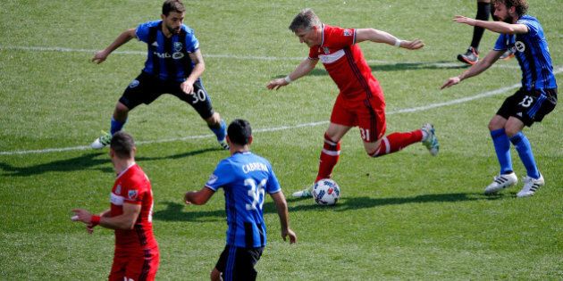 BRIDGEVIEW, IL - APRIL 01: Bastian Schweinsteiger #31 of Chicago Fire dribbles around Hernan Bernardello #30 of Montreal Impact and Marco Donadel #33 during the second half at Toyota Park on April 1, 2017 in Bridgeview, Illinois. The match ended in a 2-2 draw. (Photo by Jon Durr/Bongarts/Getty Images)