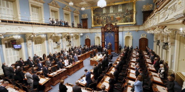 Members of the National Assembly (MNA) hold a minute of silence during a tribute to late former Quebec's Premier Jacques Parizeau at the National Assembly in Quebec City, June 2, 2015. REUTERS/Mathieu Belanger