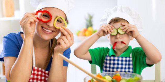 Family have fun in the kitchen with vegetables