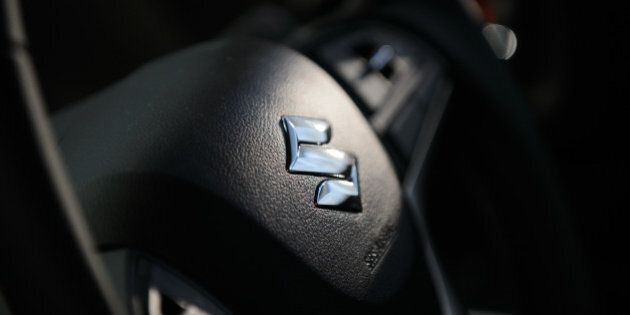 The Suzuki Motor Corp. logo sits on the steering wheel of the company's new Solio Bandit vehicle during the unveiling in Tokyo, Japan, on Wednesday, Aug. 26, 2015. Toshihiro Suzuki, 56, became president on June 30, concentrating on executing strategy set by the board, which will be headed by Osamu Suzuki, 85, who stays on as chairman and chief executive officer. Photographer: Akio Kon/Bloomberg via Getty Images