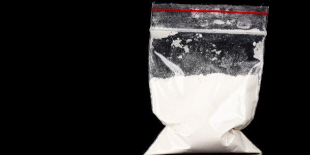 Cocaine in package on black backgroundCocaine and drugs in packages on grey backgroundCocaine and drugs in packages on grey background