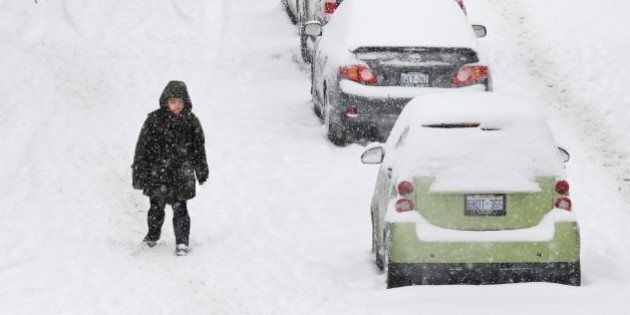 TORONTO, ON - FEBRUARY, 12 A man walks along Glen Road in the Sherbourne and Bloor area.On Sunday, Toronto was hit with a snowstorm which is quite rare this season. (Richard Lautens/Toronto Star via Getty Images)