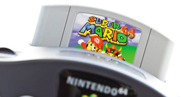 Gothenburg, Sweden - April 30, 2011: A shot of the very popular game Super Mario 64 inserted in a video game console from Nintendo, isolated on white.