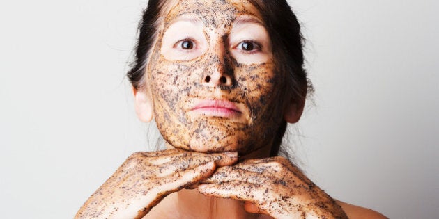 Mature woman making cosmetic mask from coffee, sour cream.