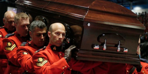 Pallbearers carry the casket of Royal Canadian Mounted Police Constable Fabrice Georges Gevaudan, one of three officers who were killed last week, during a regimental funeral in Moncton, New Brunswick, June 10, 2014. Justin Bourque, 24, was charged with murder on Friday in the slayings of the three Royal Canadian Mounted Police officers, Constables Fabrice Georges Gevaudan, 45; David Joseph Ross, 32, and Douglas James Larche, 40, during a shooting spree in the eastern Canadian city of Moncton. The shooting spree was one of the worst of its kind in Canada, where gun laws are stricter than in the United States and deadly attacks on police are rare. REUTERS/Christinne Muschi (CANADA - Tags: CRIME LAW OBITUARY)