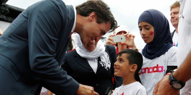 Canada's Prime Minister Justin Trudeau shakes hands with a Syrian refugee during Canada Day celebrations on Parliament Hill in Ottawa, Ontario, Canada, July 1, 2016. REUTERS/Chris Wattie