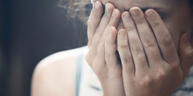 Crying woman in crisis. Close-up indoors portrait