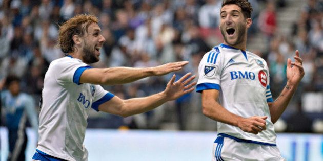 VANCOUVER, March 7, 2016 : Montreal Impact player Marco Donadel (L) celebrates his teammate Ignacio Piatti's opening goal during an MLS game in Vancouver, Canada, March 6, 2016. Montreal Impact won 3-2. (Xinhua/Andrew Soong via Getty Images)