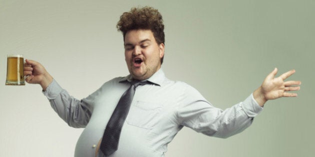 Shot of an overweight man celebrating while holding a pint of beer