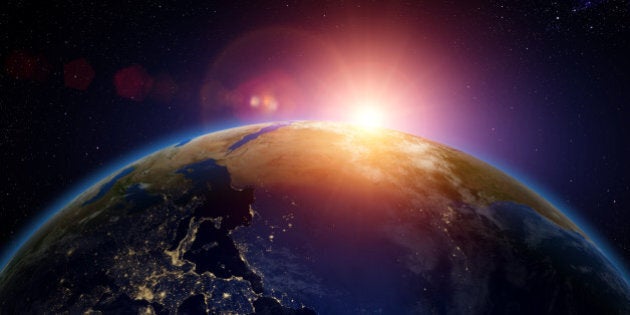 Sunrise over Europe and Africa from space with city lights visible.The globe is a composite of 3 images. Earth map images courtesy of NASA.