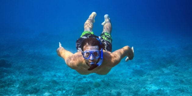 Underwater shoot of a young man snorkeling in a tropical sea. vacation concept