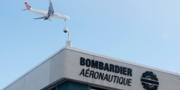 A plane flies over a Bombardier plant in Montreal, Quebec, Canada on January 21, 2014. REUTERS/Christinne Muschi/File Photo