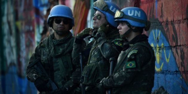 Brazilian military members from United Nations Stabilization Mission in Haiti (MINUSTAH) stand guard on a street near the Republic of Chile School in Port-au-Prince, March 27, 2017, as Chilean President Michelle Bachelet attends the inauguration of the facility. / AFP PHOTO / HECTOR RETAMAL (Photo credit should read HECTOR RETAMAL/AFP/Getty Images)