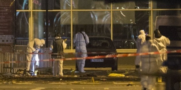 PARIS, FRANCE - NOVEMBER 13: French police forensic examiners investigate the scene outside the Stade de France after deadly shootings and explosions took place in several neighbourhoods of Paris on November 13, 2015. Reports indicate that more than 140 people overall have been killed in at least two suicide bombings, another explosion and a drive-by shooting, which targeted seven different locations. (Photo by Geoffroy Van der Hasselt/Anadolu Agency/Getty Images)