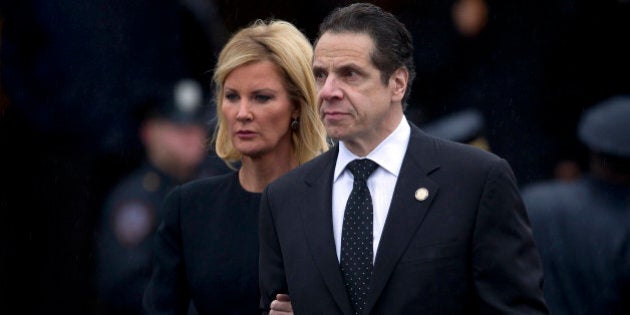 New York Governor Andrew Cuomo and his partner Sandra Lee depart the wake for slain New York Police Department officer Wenjian Liu in the Brooklyn borough of New York January 3, 2015. Liu, 32, and Rafael Ramos, 40, were shot to death on December 20 as they sat in their squad car in Brooklyn. Their killer, Ismaaiyl Brinsley, who killed himself soon after, had said he was seeking to avenge the deaths this summer of two unarmed black men at the hands of white police officers REUTERS/Carlo Allegri (UNITED STATES - Tags: SOCIETY CIVIL UNREST CRIME LAW)