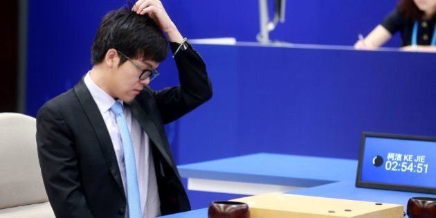 China's 19-year-old Go player Ke Jie reacts during the first match against Google's artificial intelligence programme AlphaGo in Wuzhen, east China's Zhejiang province on May 23, 2017.It's man vs machine this week from May 23 to 27 as Google's artificial intelligence programme AlphaGo faces the world's top-ranked Go player in a contest expected to end in another victory for rapid advances in AI. / AFP PHOTO / STR / China OUT (Photo credit should read STR/AFP/Getty Images)