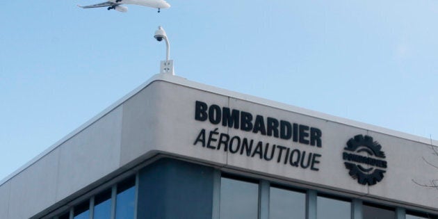 A plane flies over a Bombardier plant in Montreal, Quebec, Canada on January 21, 2014. REUTERS/Christinne Muschi/File Photo