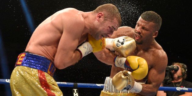 Badou Jack, right, fights Lucian Bute during a boxing match early Sunday, May 1, 2016, in Washington. The match ended in a draw. (AP Photo/Nick Wass)