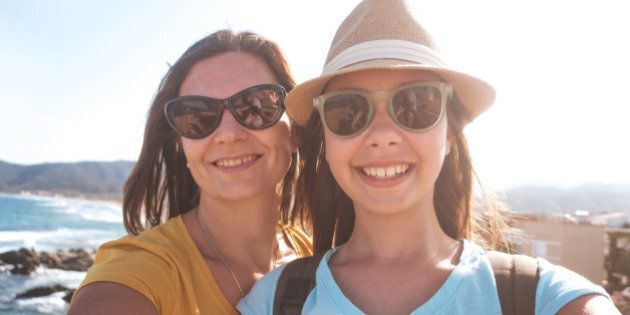 Photo of mother and daughter taking summer selfie