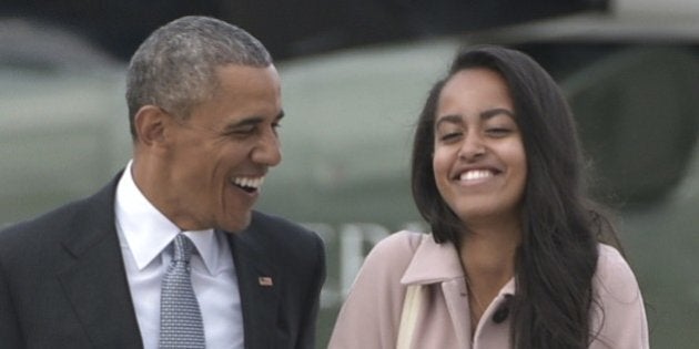 US President Barack Obama and daughter Malia make their way to board Air Force One before departing from Chicago OHare International Airport in Chicago on April 7, 2016. Obama is heading to Los Angeles to attend fundraisers. / AFP / MANDEL NGAN (Photo credit should read MANDEL NGAN/AFP/Getty Images)