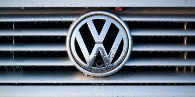 'Padua, Italy - July 6, 2011: Wet Volkswagen metallic logo on a car hood. Volkswagen is a German, world famous, motor vehicles manufacturer brand which also owns the Audi, Bentley, Bugatti, Lamborghini, SEAT, and A koda marques. The world Volkswagen means -people car- in German.'