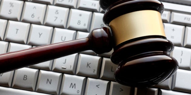 A gavel on a computer keyboard representing an internet auction or computer related crime.