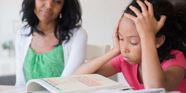 Mother helping daughter with homework